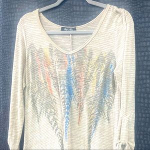 This large symmetry feather shirt is a western girls staple